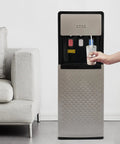 Person using Bottom Loading Water Dispenser With Three Water Modes Hot Cold And Room Temperature, Standing Hydration Station