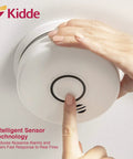 Close-up of hand testing Smoke And Carbon Monoxide Detector With 10 Year Battery And Voice Alert Interconnected Combo Alarm For Your Home Safety