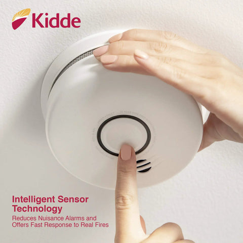 Close-up of hand testing Smoke And Carbon Monoxide Detector With 10 Year Battery And Voice Alert Interconnected Combo Alarm For Your Home Safety