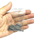 Hand holding a small plastic bag containing a set of 3/32 x 3/4 metal dowel pins, part of the Three Thirty Second Inch By Three Quarter Inch Dowel Pins Set Of Thirty Metal Dowel Pins Shelf Pegs For Shelves Supports Bearings Alloy Steel Wood Bunk Bed Pegs For Furniture Repair.