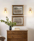 Vintage Rechargeable Wall Sconce Set With Amber Tulip Glass Shade And Wireless Remote For Zero Wiring Bedroom Decor installed beside framed art.