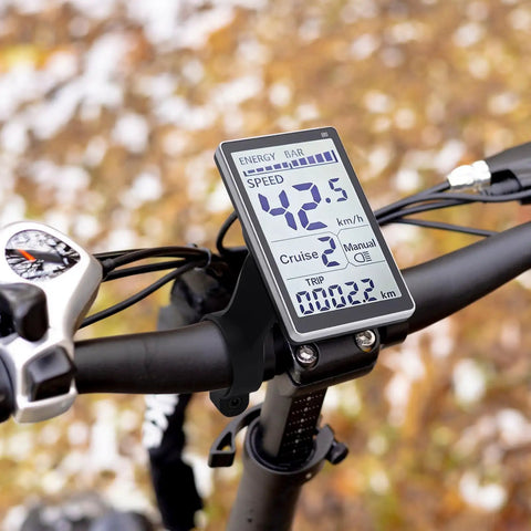 Universal 5 Pin LCD Display Meter for E Bikes and Scooters mounted on handlebars showing speed and energy levels.
