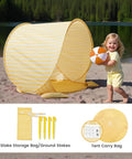 Child playing near Pop Up Baby Beach Tent With 2026 Upgraded UV Protection Lightweight Portable Sun Shelter on sandy beach.