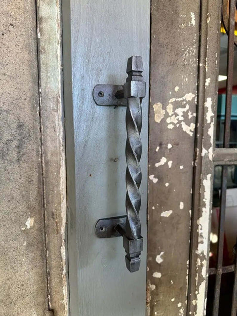 Set Of 2 Oversized Cast Iron Door Pull Handles With Twisted Forged Design for a rustic exterior door