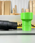Hose Adapter For Festool 27mm To Dewalt Milwaukee And Ridgid 2 1 4 Inch Table Saws Delivers Easy Dust Collection And A Cleaner Workshop With Rear Port Compatibility. Green 27mm to 2-1/4 inch adapter beside a hose, on a table saw.