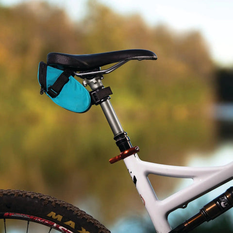 Bicycle with Valais Seat Bag Adapter For 26mm Dropper Posts holding turquoise saddle bag, mounted on 26 to 26.5mm stanchions
