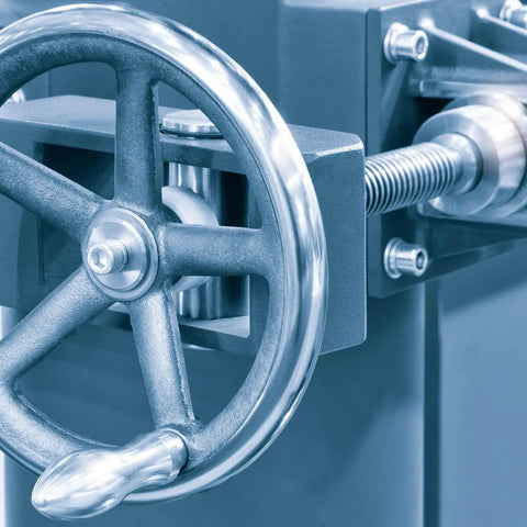 Close-up of machine handle connected to threaded rod.