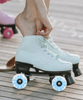 Person wearing skates with Lit Up Roller Skate Wheels 4 Pack Blue LED Quad Wheels for Outdoor Skating on wooden deck