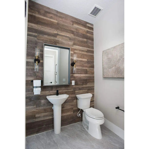 Bathroom with Two Light Clear Glass Farmhouse Bath Vanity Light In Antique Bronze Finish next to mirror.