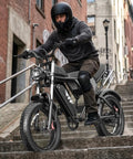 Person riding Offroad 1500W Peak Motor Fat Tire Electric Bike With 30 MPH Top Speed, 48V 15.6Ah Removable Battery down stairs