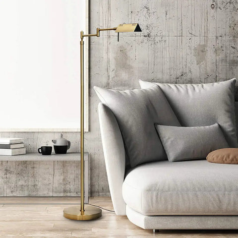 Dimmable LED Pharmacy Floor Lamp With 12W LED Full Range Dimming 360 Degree Swing Arms Adjustable Height Standing Lamp For Reading Sewing And Craft ETL Listed Antique Brass Gold Finish next to a gray sofa