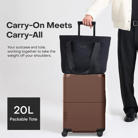July Carry On Max expandable 21.5-inch brown rolling luggage with black travel tote, front view