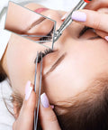 Close-up of a three piece telescoping inspection mirror set with a square mirror being used for precise eyelash inspection.