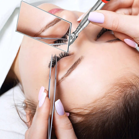 Close-up of a three piece telescoping inspection mirror set with a square mirror being used for precise eyelash inspection.
