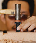 Person using a hammer with a 4 Pack Heavy Duty Sliding Barn Door Track Spacers Kit With Adjustable Carbon Steel Connectors And Bolts