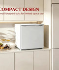 Slick Compact 1.1 Cu Ft Mini Freezer With Smooth Five Step Temperature Control And Reversible Door positioned in a modern kitchen.