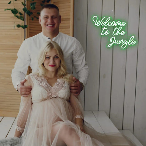 Couple sitting in front of Welcome To The Jungle Neon Sign Green LED Light For Wall Decor USB Powered Jungle Theme Decor