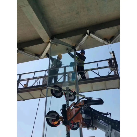 Workers using Heavy Duty Vacuum Glass Robot With Electric Multi Axis Glass Lifter for glass installation on construction site.