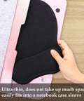 Hand placing ergonomic mouse pad with wrist rest memory foam for computer, home office and gaming into pink notebook case.