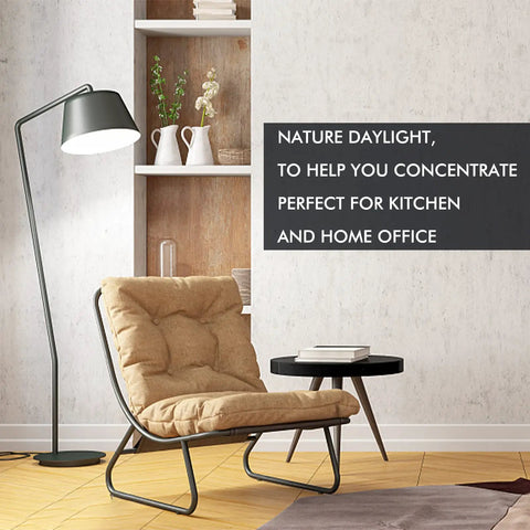 Living room setup with a chair and lamp showcasing Emergency Rechargeable Light Bulbs With Battery Backup For Power Outages Stay Lit During Blackouts 15W 80W Equivalent 6000K Daylight 1200mAh Self Charging Bulbs For Home Hurricane Prep Pack Of 4