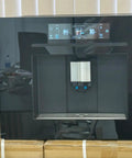 Next Level Built In Fully Automatic Coffee Maker With Glossy Black Glass Panel And Smart Touchscreen Interface front view with digital display.