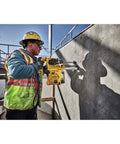 Construction worker using Onboard Dust Extractor for 1-1/8-Inch SDS Plus Rotary Hammers With Clear Dust Box and Replaceable Nozzle