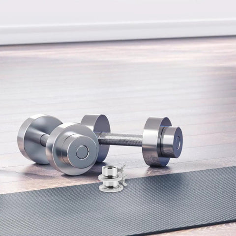 Two Pack Steel Barbell Collars And Dumbbell Clamps With Anti Slip Screw Locks on a gym floor