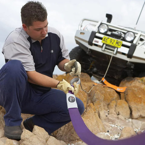Man rigging a Beefy Winch Extension Strap For Tough Recovery 9900 Lbs Breaking Strength 66 Ft Long 3 Inches Wide Non Stretch