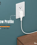 Right Angle Nema 1-15P To Nema 1-15R Power Adapter plugged into wall outlet with cord extended, showing vertical orientation.