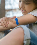 Child with blue bandage on arm, 100 Pcs Blue Bandages 3 By 1 Inch Metal Detectable Waterproof PE Adhesive Bandages For Food Handling And Kitchen Use
