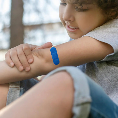 Child with blue bandage on arm, 100 Pcs Blue Bandages 3 By 1 Inch Metal Detectable Waterproof PE Adhesive Bandages For Food Handling And Kitchen Use