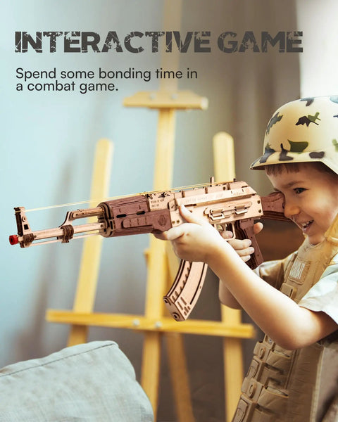 Child playing with Wooden 3D AK47 Puzzle Model With Rubber Band Shooter Detachable Magazine And Two Fire Modes Cool DIY Kit