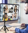 Extendable Desk Webcam Tripod Stand For Cameras And More used for a video conference on a desk.