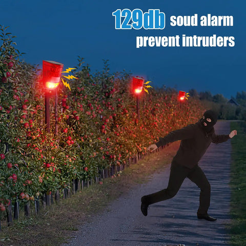 Solar Powered Motion Sensor Alarm System With 129dB Outdoor Siren Waterproof Deterrent strobe lights at night in action.