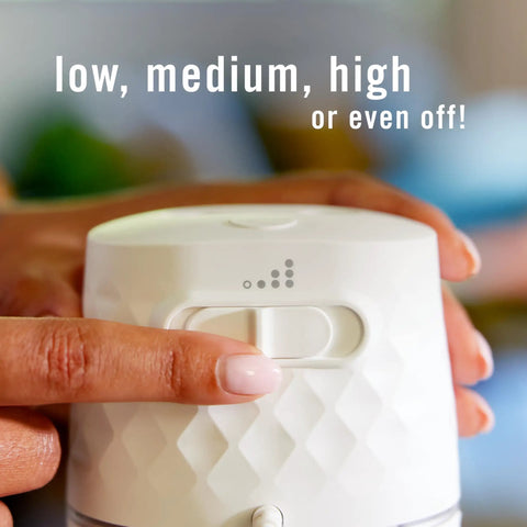 Hand adjusting settings on Plug In Scent Booster Starter Kit With Ocean Refills, Black Oil Diffuser Air Freshener