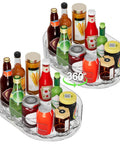 Clear Rectangular Lazy Susan For Refrigerator Smooth As Butter Turntable Organizer Total Breeze For Condiments And Spice Jars Hella Game Changing Pantry Cabinet Rack Fits Snug On Kitchen Countertop Two Piece Set with various bottles and jars arranged.