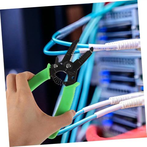 Hand holding Portable Wire Stripper Pliers With Soft Grips rapidly stripping copper jacketing in electrical work.