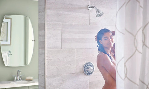Woman enjoying shower with Gibson Chrome Pressure Balancing Eco Performance Showerhead With Handle And Tub Spout For A Fresh Spa Vibe