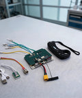 36V 10S Dual Drive ESC Controller Board with 2.4G Wireless Remote for Electric Skateboards and Longboards, components displayed on table.