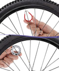 Hands using 7 Piece Bicycle Spoke Wrench Kit, Steel Spoke Torque Tool Set for wheel tension and alignment adjustment.