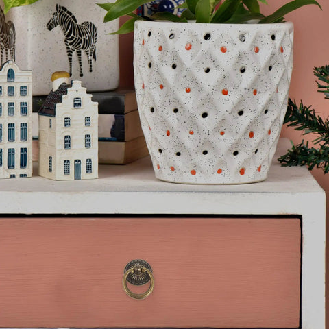 Close-up of a vintage ring pull handle on a pink drawer, part of a Vintage Ring Pull Handles 8 Pack With Antique Bronze Finish For Cabinets Drawers Dressers And Furniture Hardware Durable Metal With Screws For Easy DIY Installation.