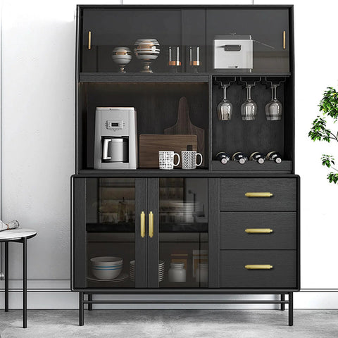 Modern kitchen cabinet with black finish, showcasing glassware, mugs, and a coffee maker. Gold pull handles for wardrobe cabinets.