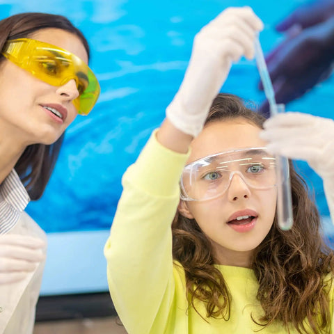 Young girl using Graduated Dropper Pipettes Kit 3 Pack 0.5ml 1ml 5ml Borosilicate Glass with guidance from teacher in science lab