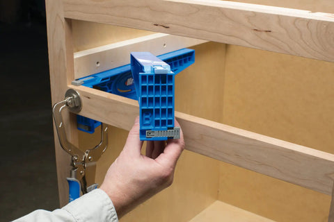 Person using Drawer Slide Jig And Concealed Hinge Jig Kit For Cabinets And Desks, No Fuss Install Of Cabinet Slides on a cabinet.