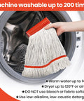 Six Pack Safety Orange Cotton Mop Head Replacements Built Tough Heavy Duty String Refills being placed in a washing machine for cleaning.