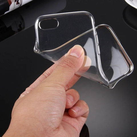 Clear flexible phone case held in hand showing transparency and flexibility on black background.