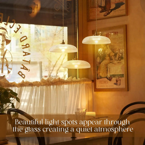 11.8 Inch Retro Glass Pendant Light With Clear Glass Shade And Antique Brass Finish, illuminating a cafe setting.