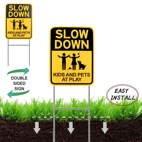 Slow Down Signs With H Stake 16x12 Inches Kids And Pets At Play Double Sided Street Safety Signs installed on grass, metal stakes.