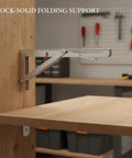 Heavy Duty Stainless Steel L Shaped Folding Shelf Bracket Wall Mount supporting a wooden workbench surface