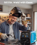 Man using 135A MIG Welder 110V 3 In 1 Gasless Flux Core Lift TIG Stick Welding Machine Portable Inverter in home workshop
